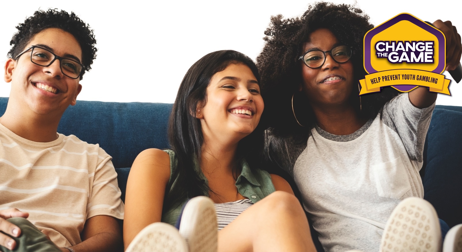 Three young adults sitting on a couch