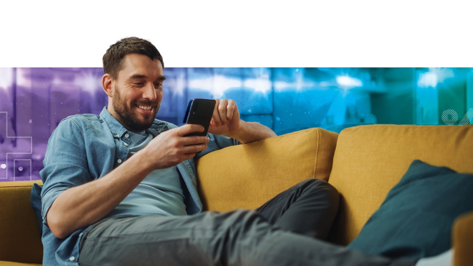 Man sitting on a couch using a smartphone